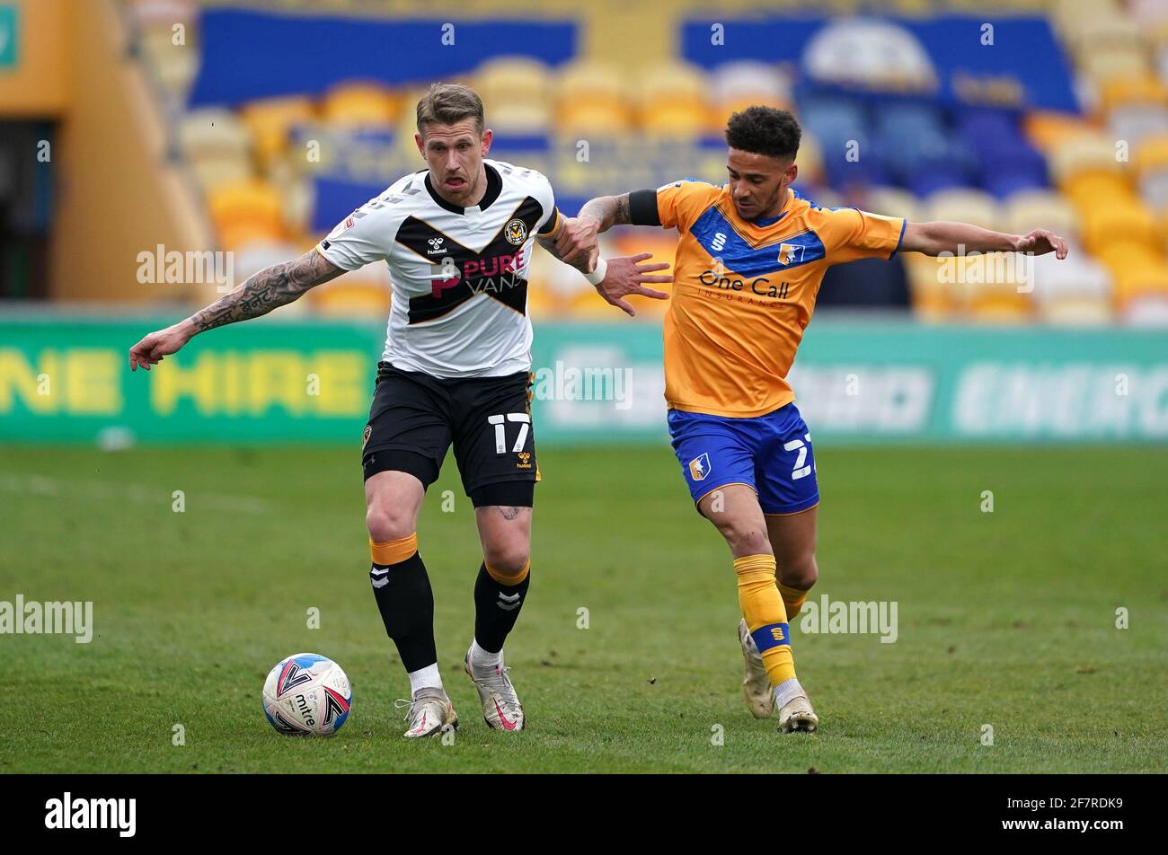 Mansfield Town's Tyrese Sinclair (left) and Newport County's Scot Bennett battle for the ball during the Sky Bet League Two match at Field Mill, Mansfield. Picture date: Friday April 9, 2021. Stock Photo