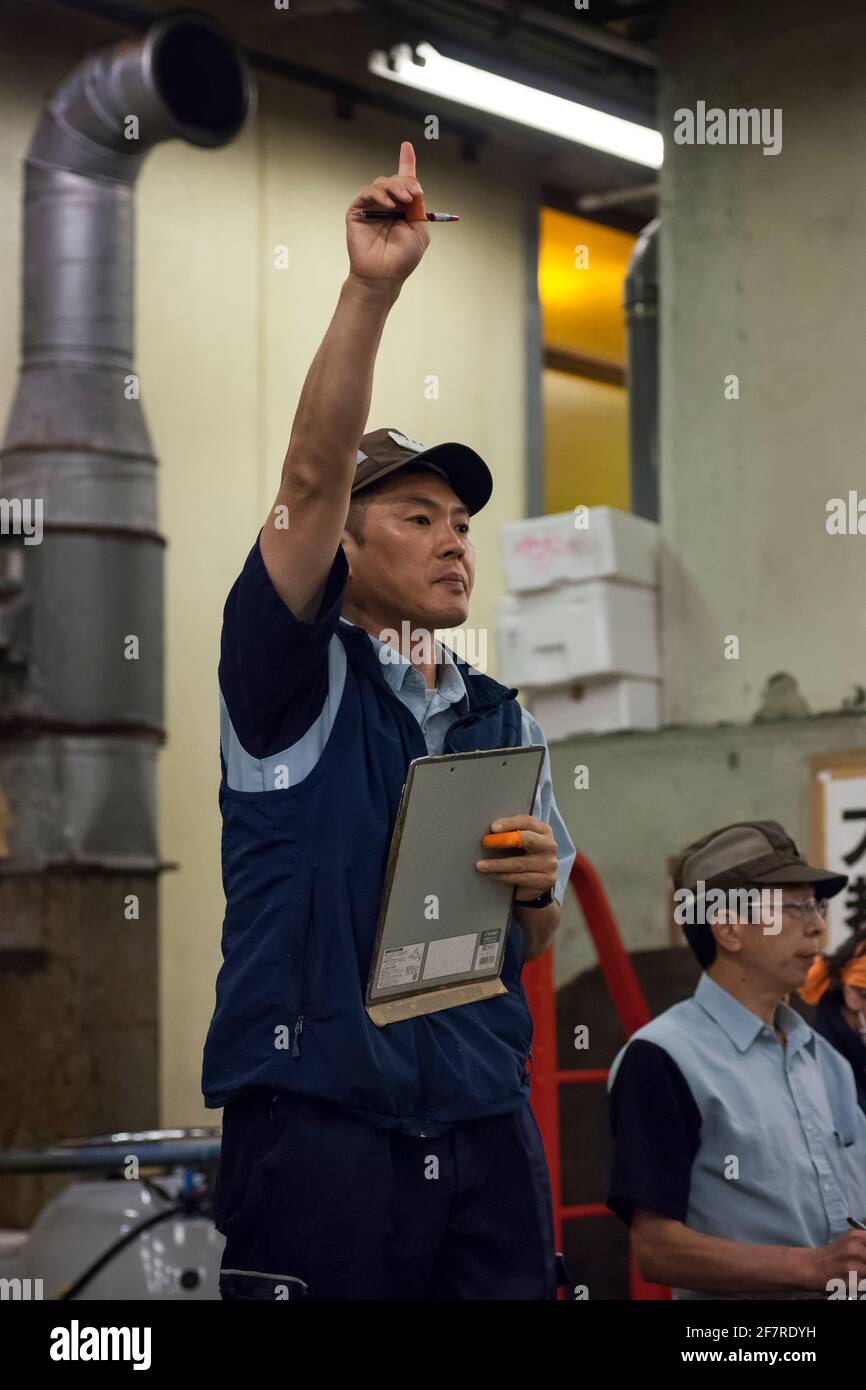 Vertical close-up view of the auctioneer of the early morning tuna auction in the old Tokyo's Tsukiji fish market, Tsukiji, Tokyo, Japan Stock Photo