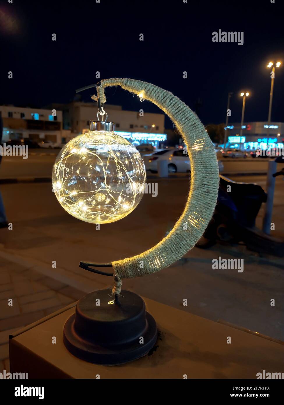 Moon shape LED decorative table lamp closeup,blurry background,religious symbol,Islamic Ramadan Stock Photo
