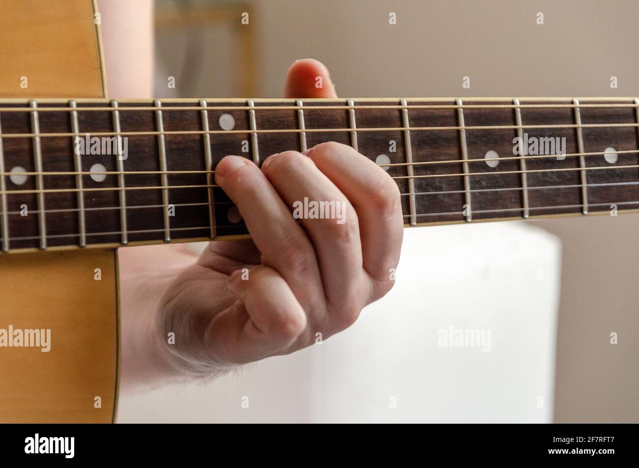 closeup on male fingers playing acoustics arm guitar strings Stock Photo