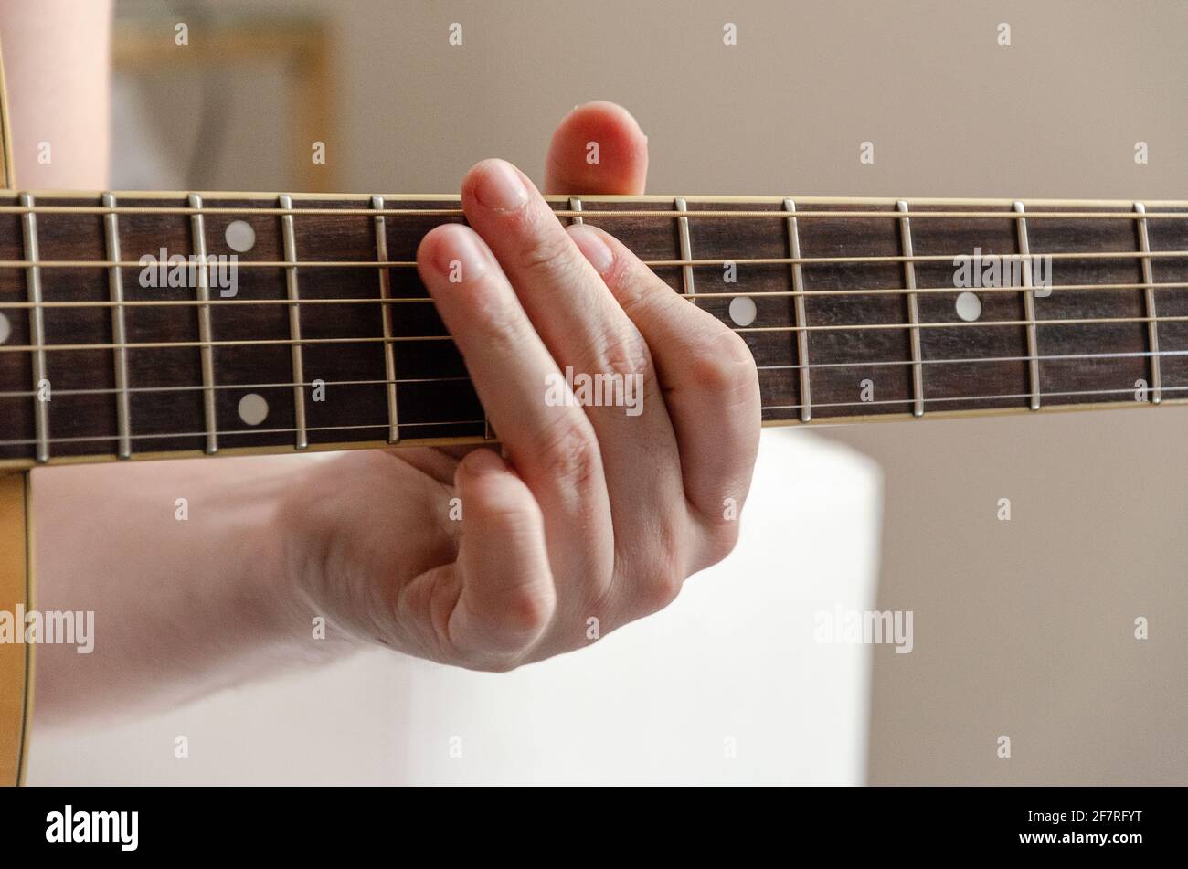 closeup on male fingers playing acoustics arm guitar strings Stock Photo