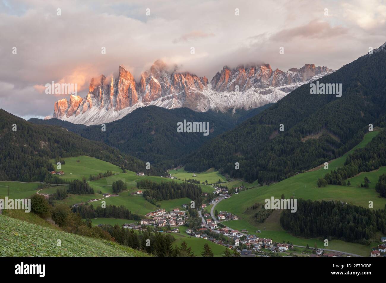 Small Italian mountain town of St. Magdalena in Val di Funes at sunset Stock Photo