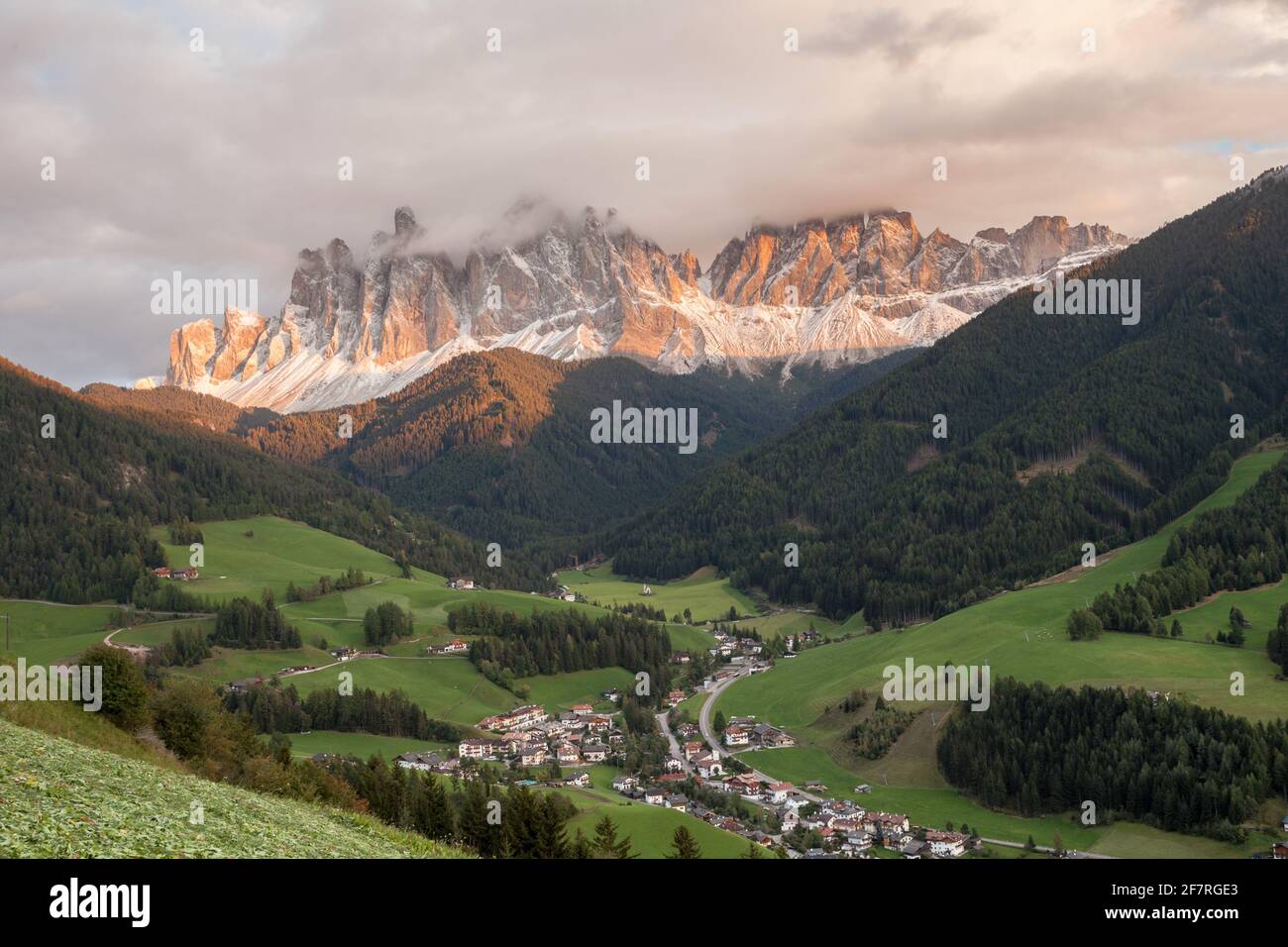 Small Italian mountain town of St. Magdalena in Val di Funes at sunset Stock Photo