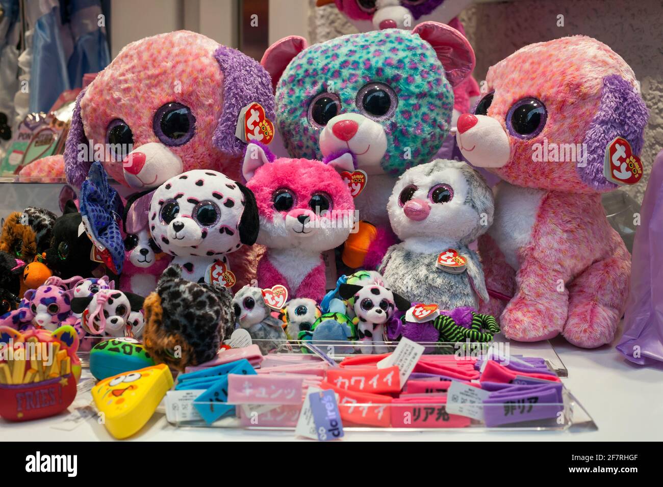 Horizontal close up view of the colorful cuddly toys in a toy