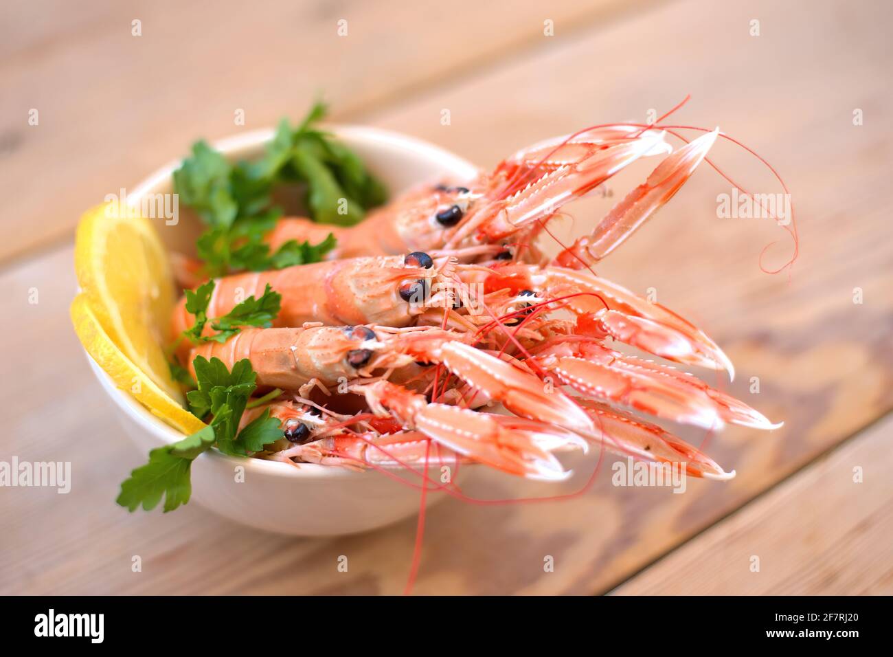 boiled crayfish, with oil and lemon sauce, on a plate, karavides in Greek Stock Photo