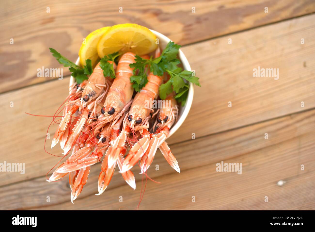 boiled crayfish, with oil and lemon sauce, on a plate, karavides in Greek Stock Photo