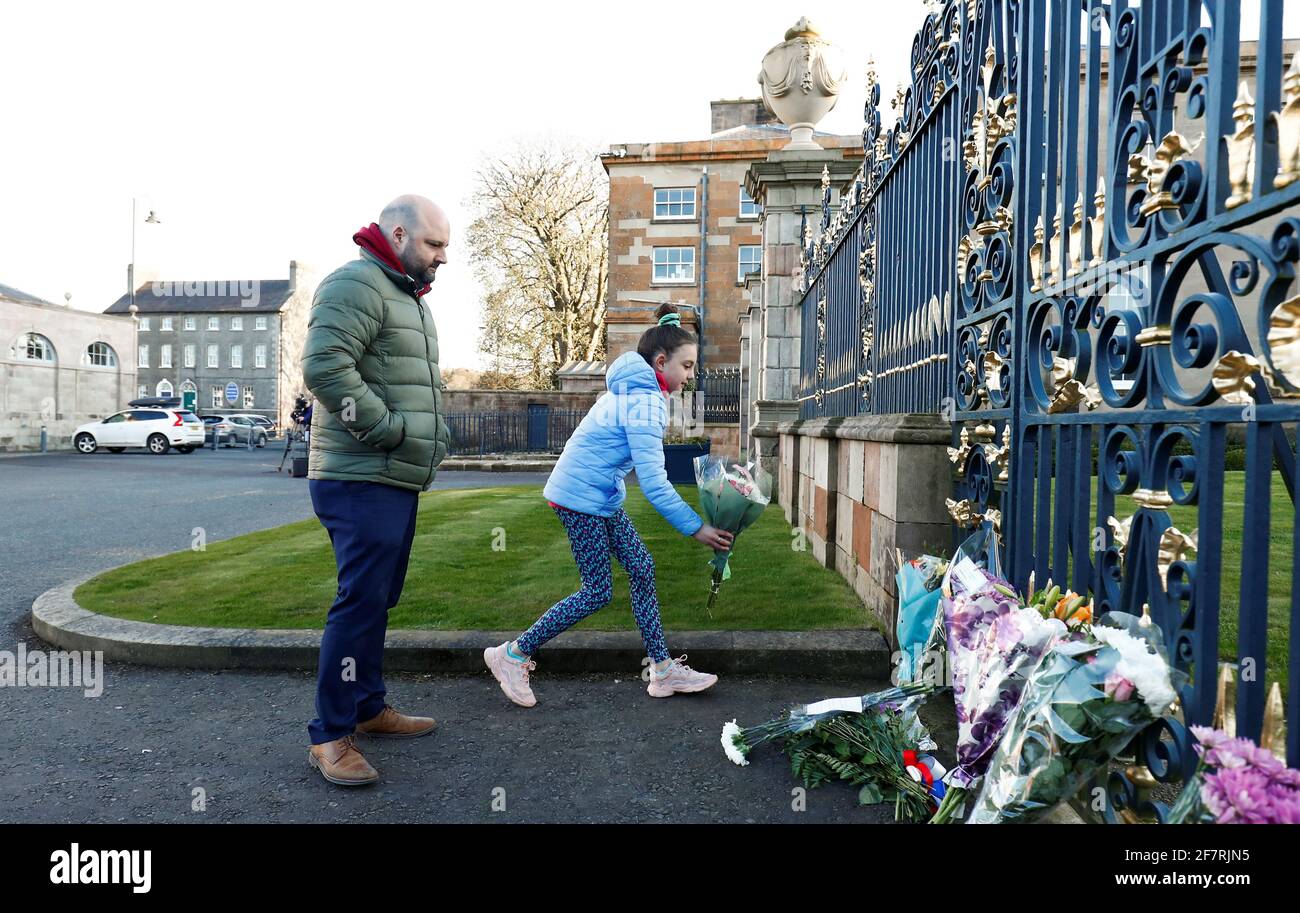People bring flowers to Hillsborough Castle after Britain's Prince Philip, husband of Queen Elizabeth, died at the age of 99, in Hillsborough, Northern Ireland, April 9, 2021. REUTERS/Jason Cairnduff Stock Photo
