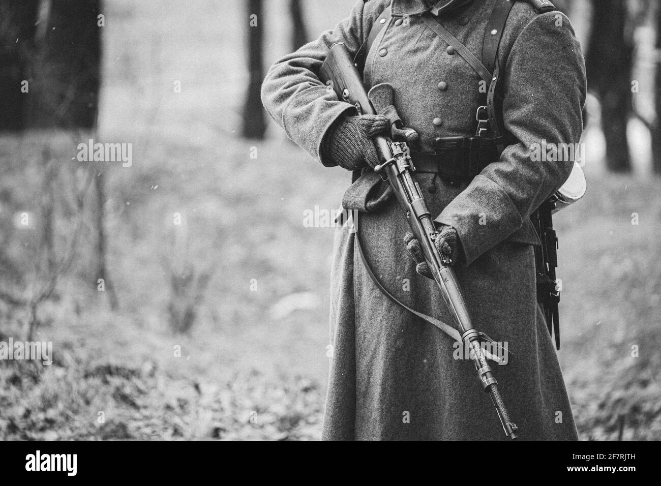 Close up of German military ammunition of a German soldier at World War II. Warm autumn clothes, soldier's overcoat, gloves, rifle. Black And White Stock Photo