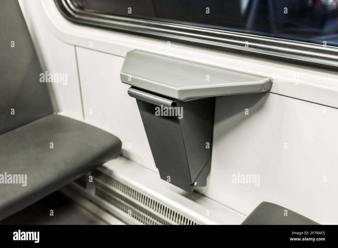 Compact waste bin in the interior of a modern stadler electric train ...