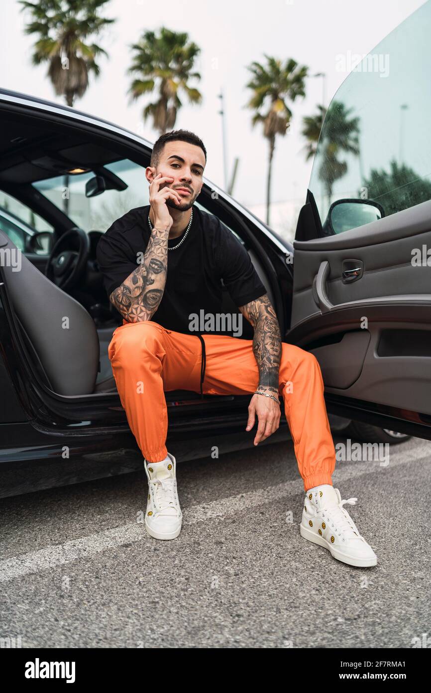 handsome stylish man in sunglasses smiling and posing in car Stock Photo -  Alamy