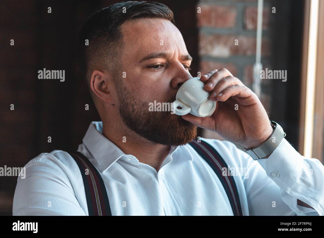 Young businessman drinking espresso coffee in a cafe Stock Photo