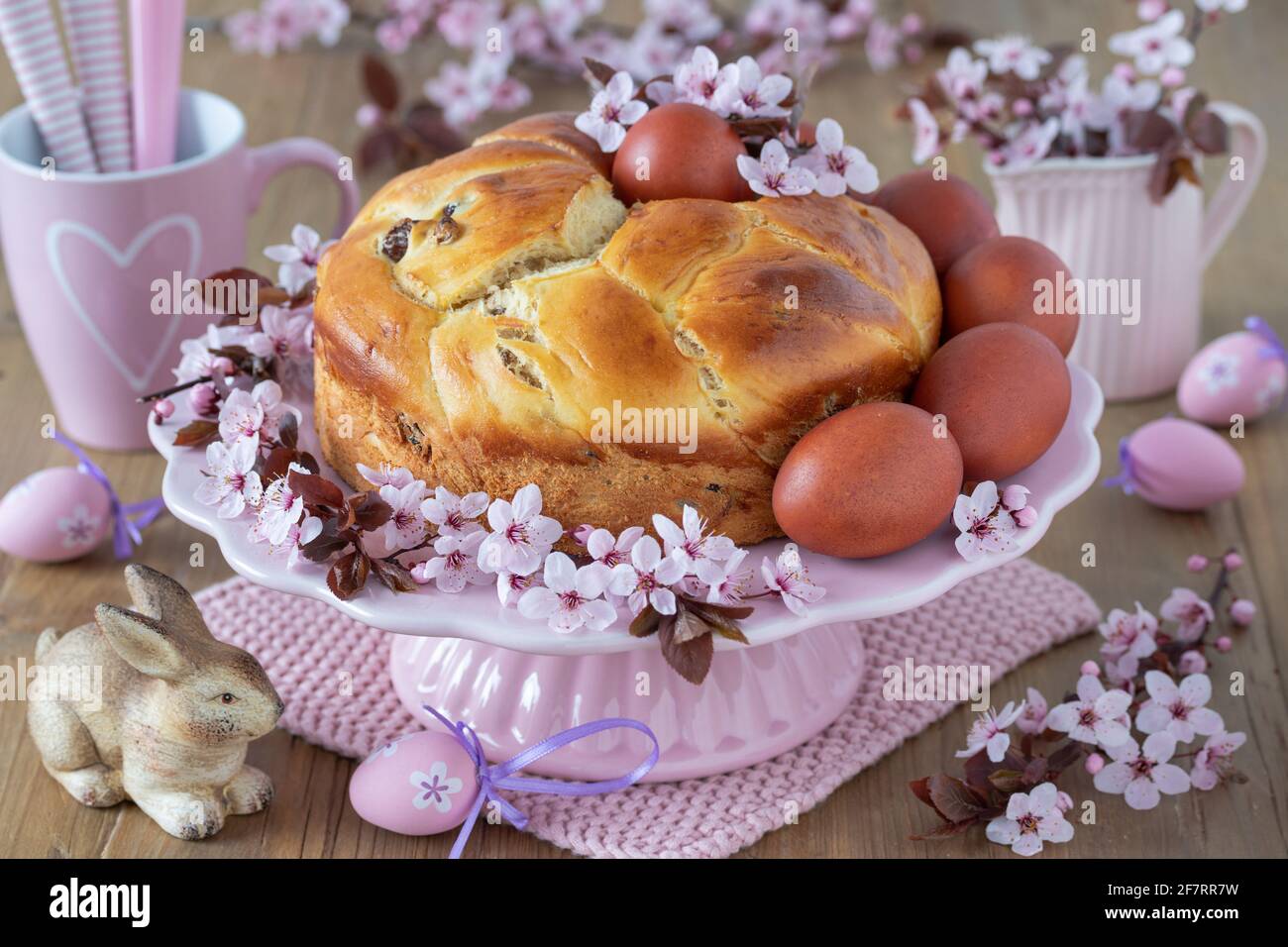 easter bakery yeast plait cake, coloured eggs and cherry blossom Stock Photo