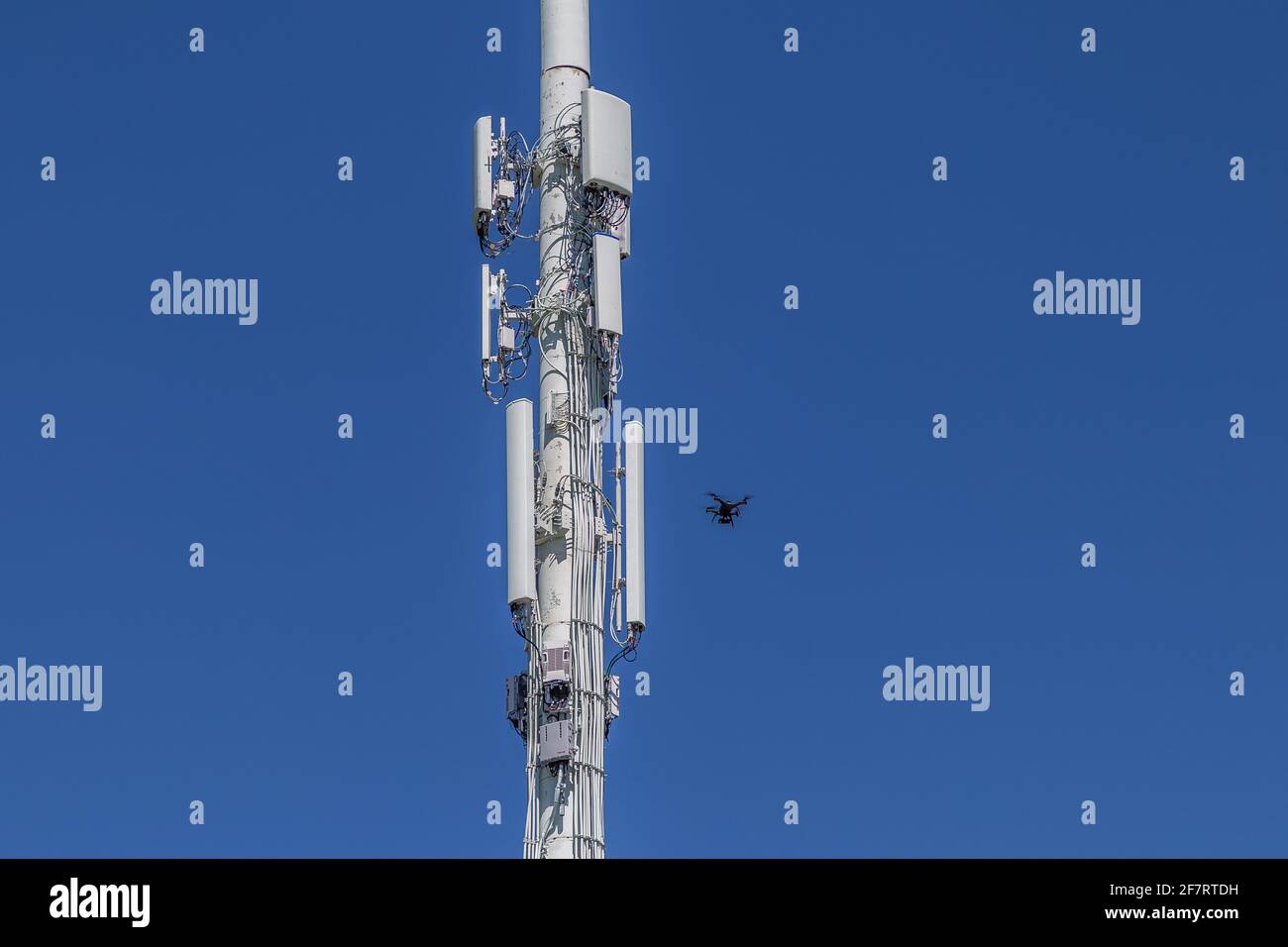 Drone Inspecting lower right of a cell tower Stock Photo