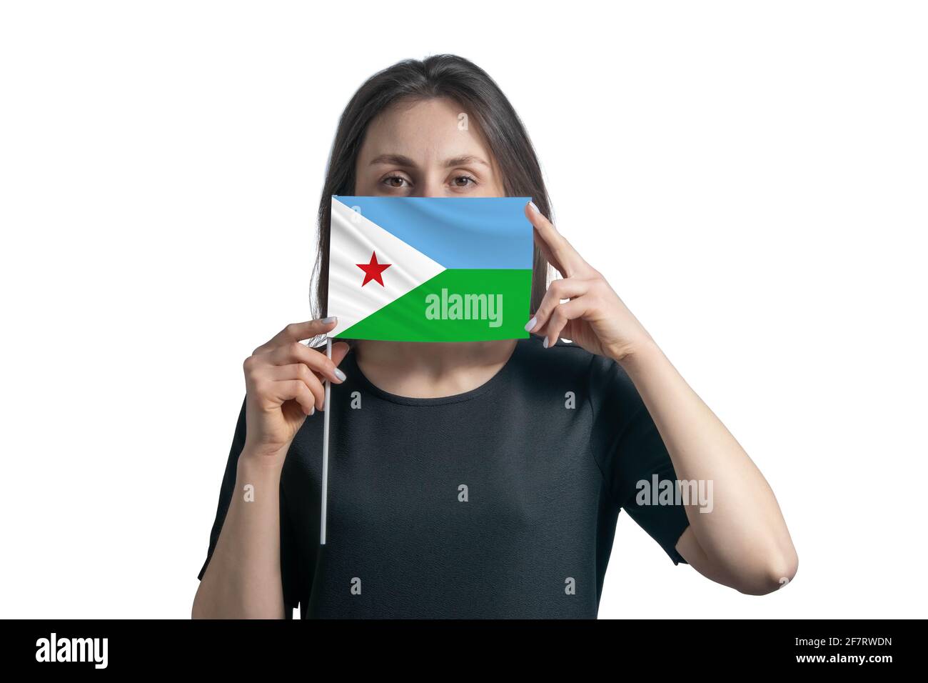 Happy young white woman holding flag Djibouti flag and covers her face with it isolated on a white background. Stock Photo