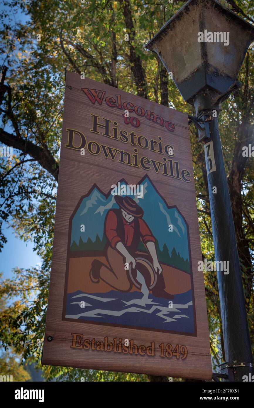 Welcome to Downieville  sign hanging from a lamp post on main street, featuring ngolden leaves in the background. Downieville was founded in 1849 duri Stock Photo
