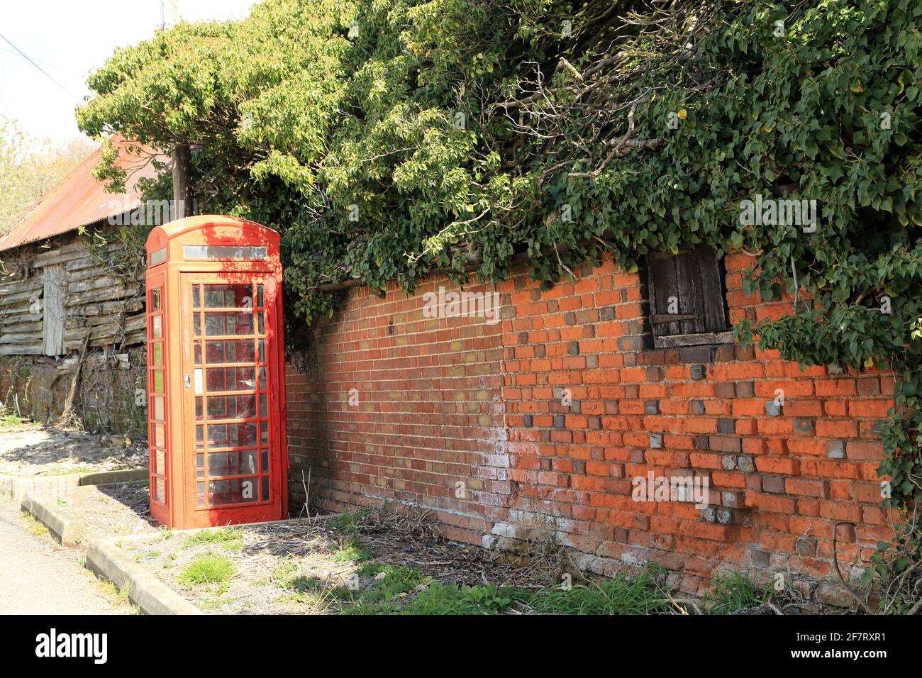 Old red telephone box and red letterbox in village of Stowting on the edge of the North Downs, Stowting Hill, Stowting, Kent, United Kingdom Stock Photo
