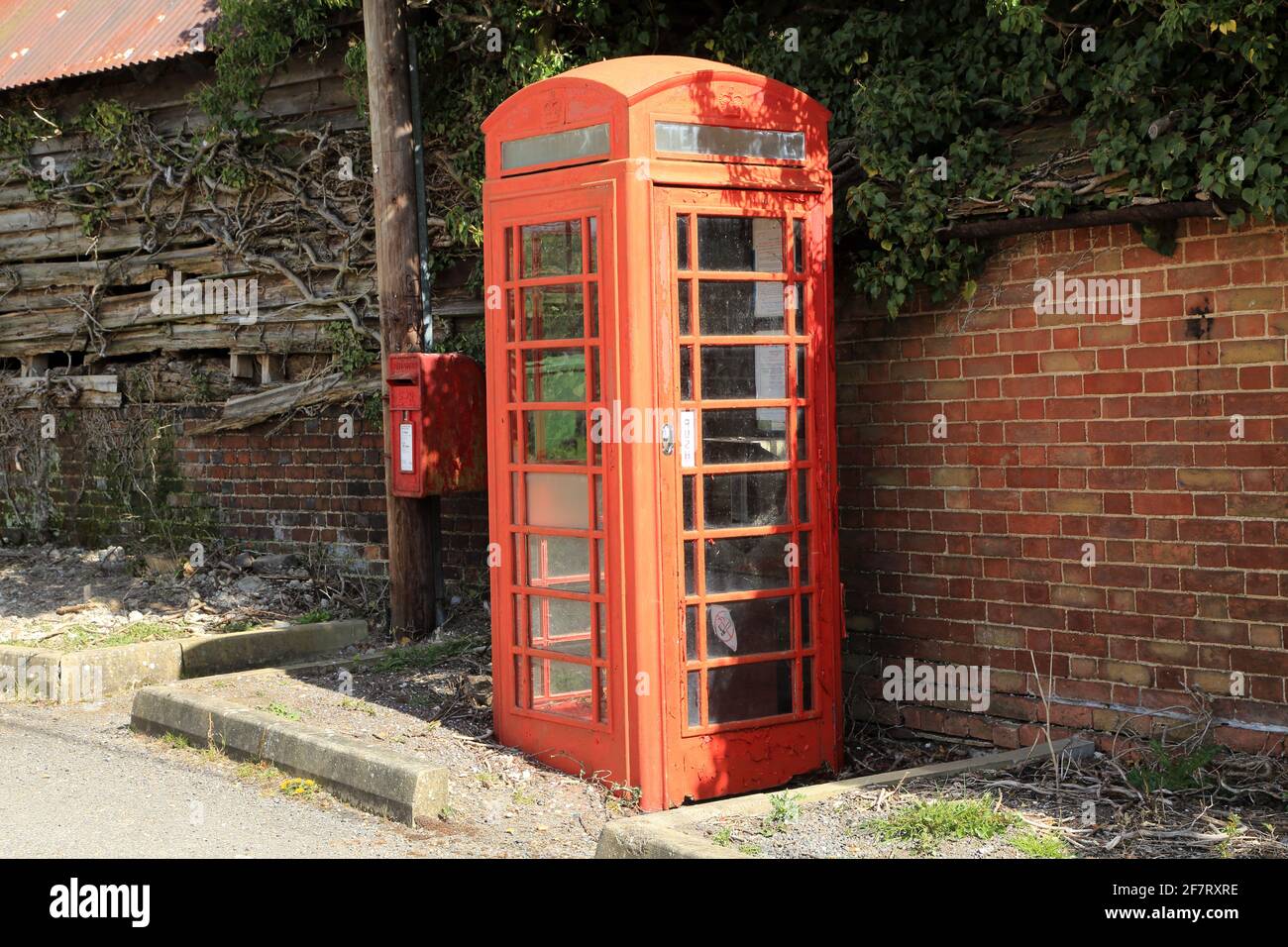 Old red telephone box and red letterbox in village of Stowting on the edge of the North Downs, Stowting Hill, Stowting, Kent, United Kingdom Stock Photo