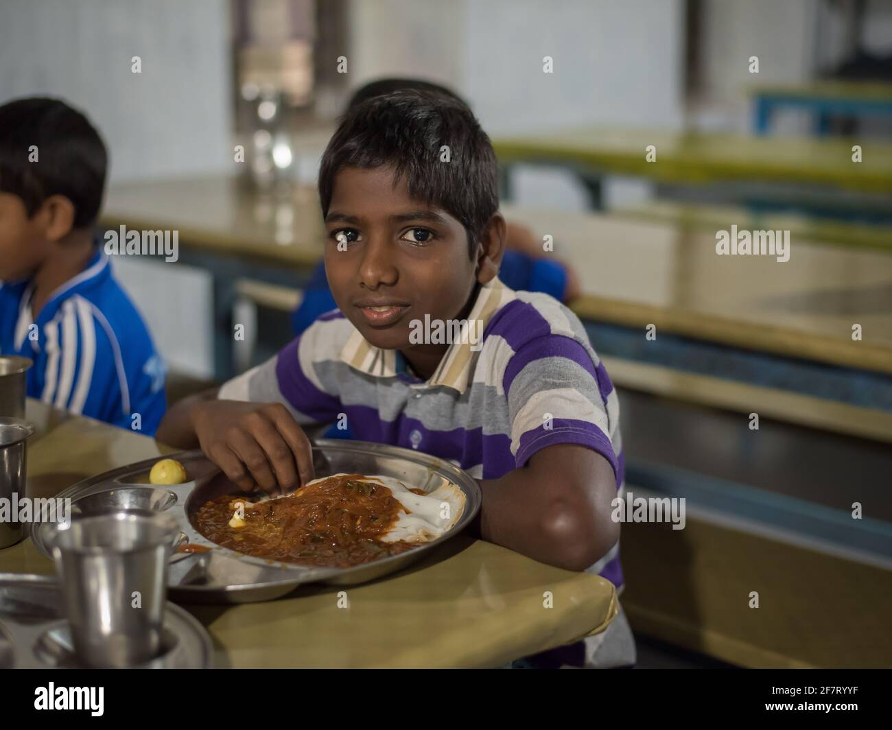 Varanasi, India. 10-14-2019. Portrait of a boy having lunch at school after the morning class finish and before the school sport activities when they Stock Photo