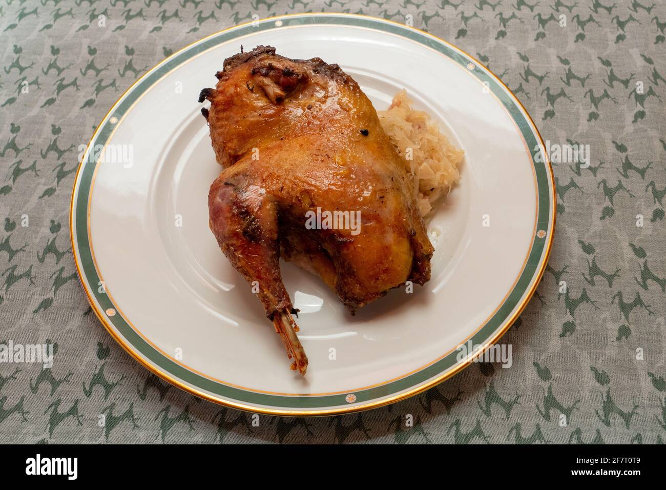 Half Roast or Braised Pheasant on Sauerkraut, on a Plate, in Traditional Alsatian Style Stock Photo