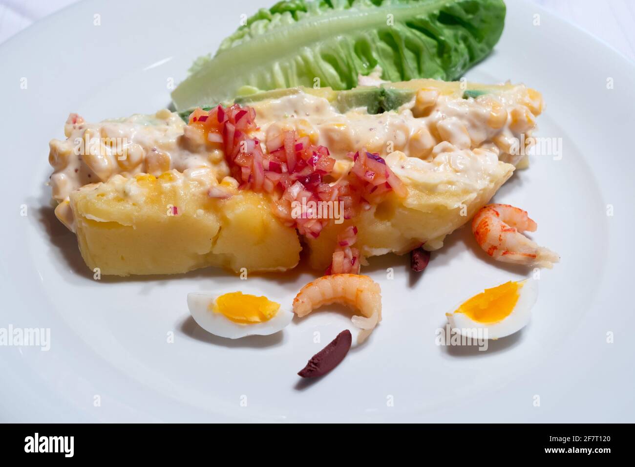 Causa Limena, a Typical Dish in Peruvian Cuisine Served with Onions, Crayfish and Quail Eggs Stock Photo