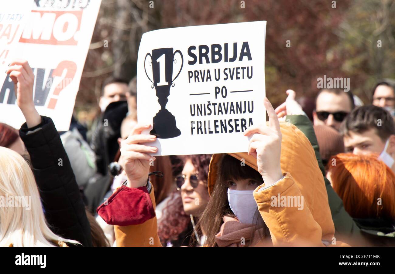 Belgrade, Serbia - April 8,  2021: Young woman holding a placard  in Serbian freelance online workers protest against retroactive taxes and ignorant M Stock Photo