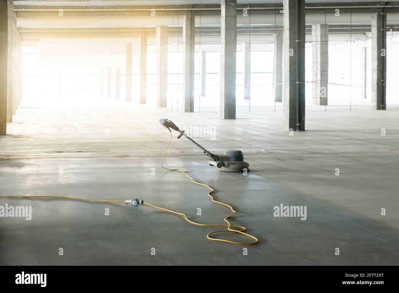 floor polishing machine inside a large industrial building, not people ...