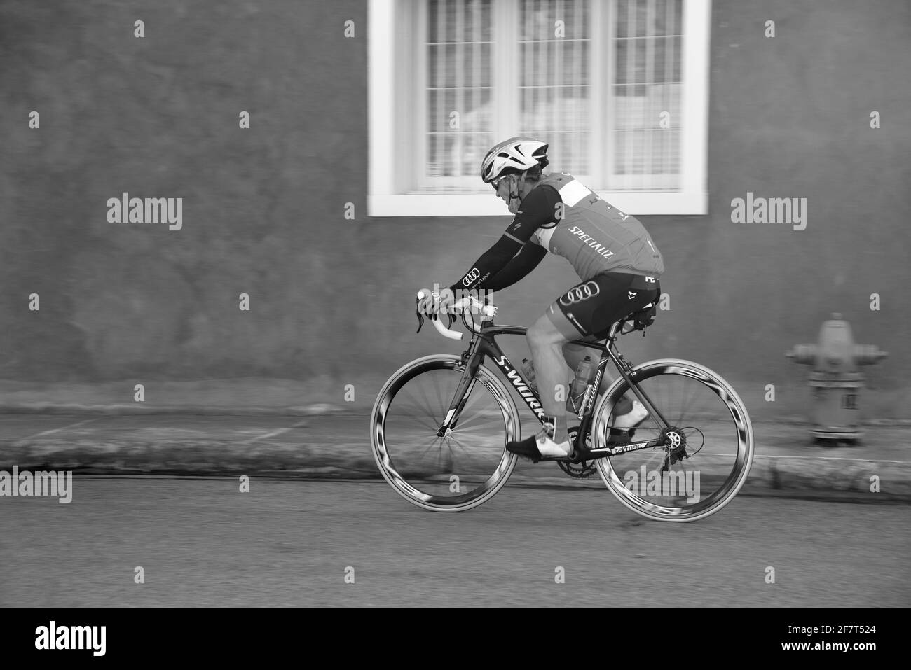 An active senior man rides his bicycle along a road in Santa Fe, Nee Mexico. Stock Photo