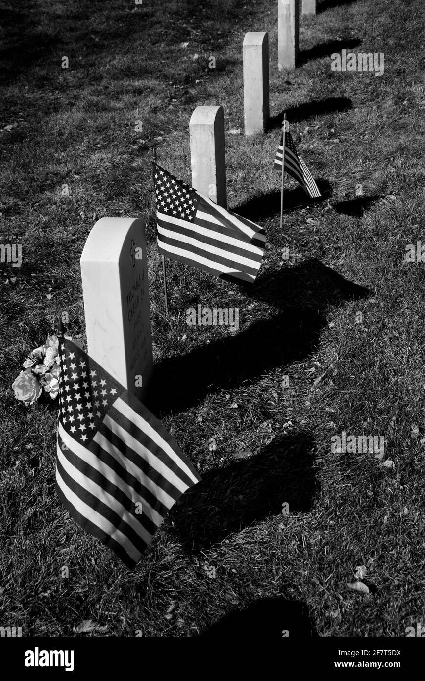 American flags decorate graves of U.S. military veterans buried at Santa Fe National Cemetery in Santa Fe, New Mexico. Stock Photo