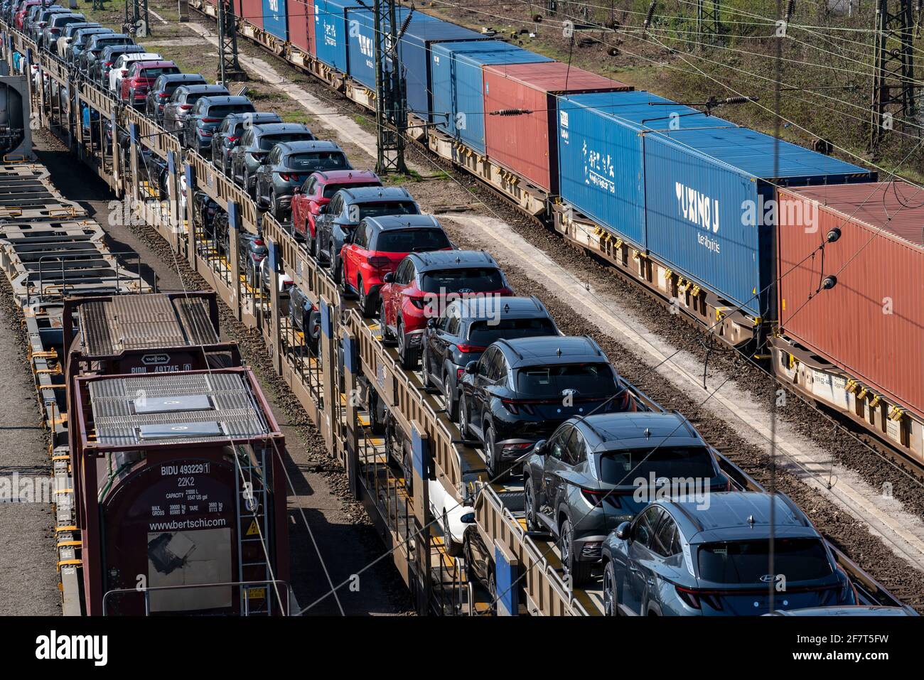 Duisburg-Rheinhausen freight station, at the Logport port area, goods trains loaded with new cars, various tank containers and the container train fro Stock Photo