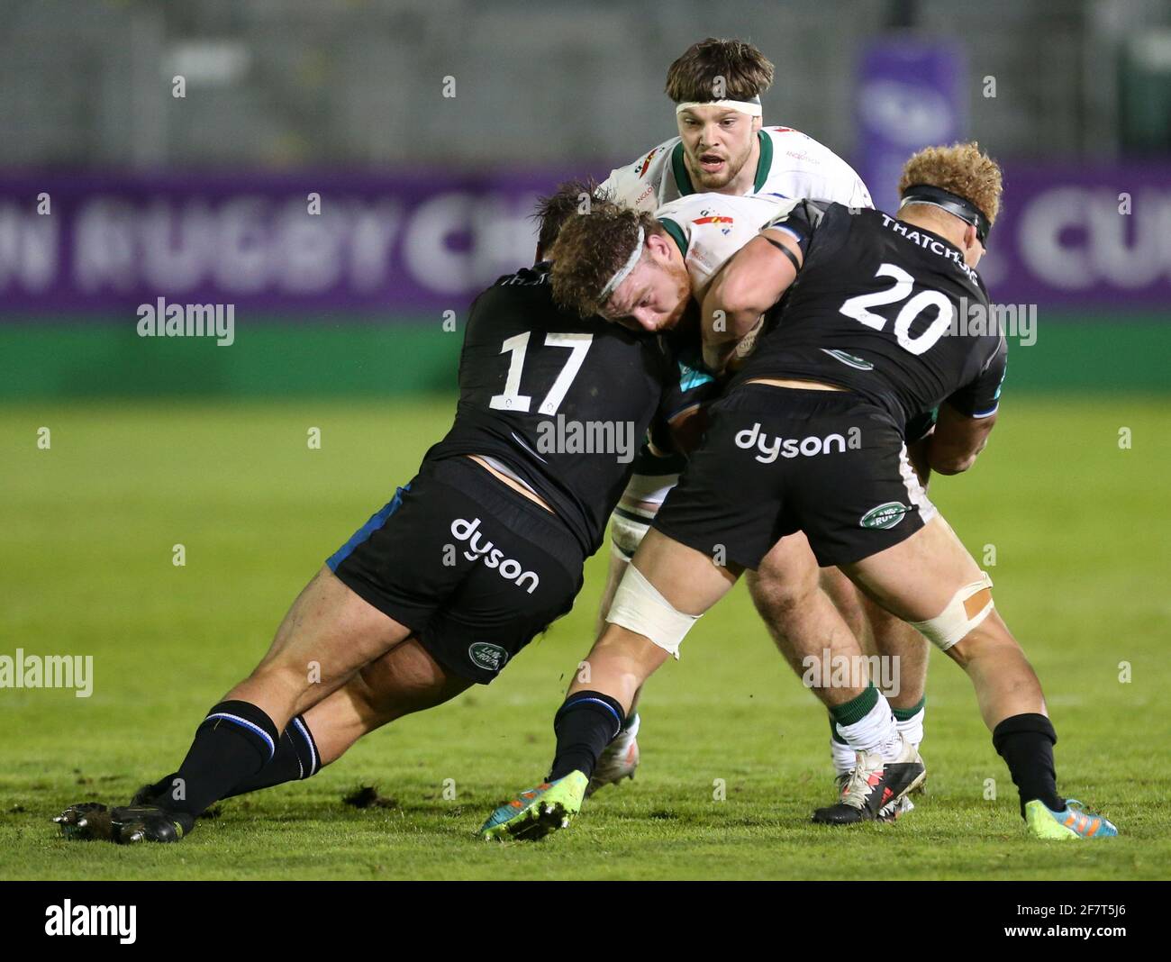 London Irish's Harry Elrington is tackled by Bath Rugby's Juan Schoeman (left) and Miles Reid (right) during the Challenge Cup, quarter final match at the Recreation Ground, Bath. Picture date: Friday April 9, 2021. Stock Photo