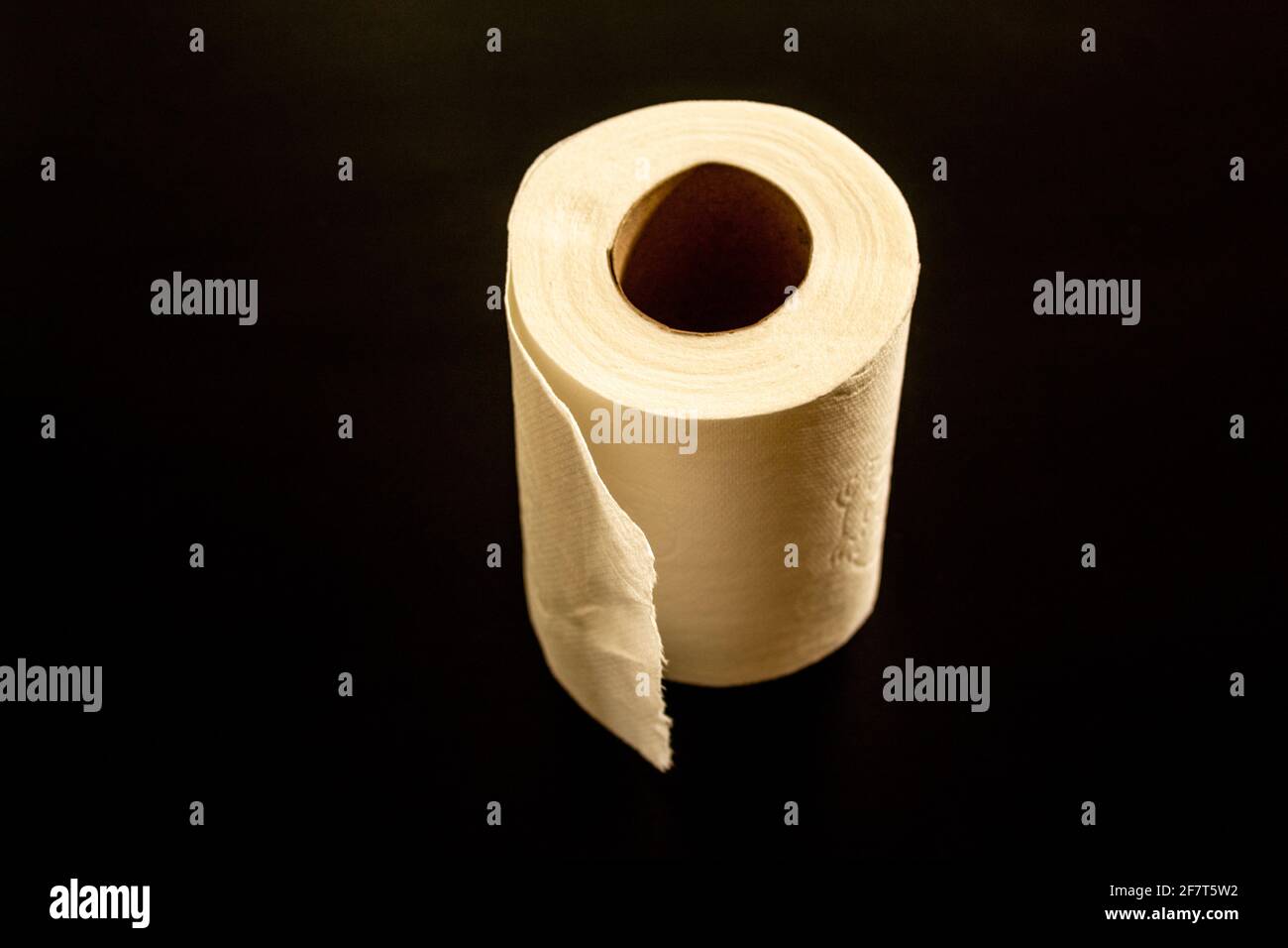 A roll of toilet paper in a black background Stock Photo Alamy