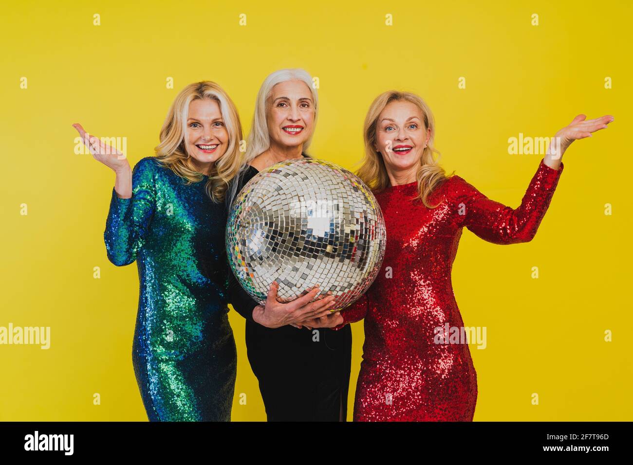 Beautiful senior women with festive elgant dress having fun at a party -  Group of sexy mature ladies with eccentric fashionable look poising on  clored Stock Photo - Alamy