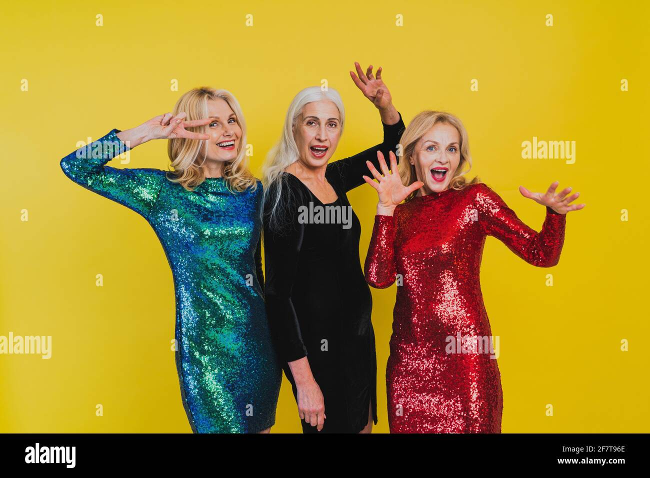 Beautiful senior women with festive elgant dress having fun at a party -  Group of sexy mature ladies with eccentric fashionable look poising on  clored Stock Photo - Alamy