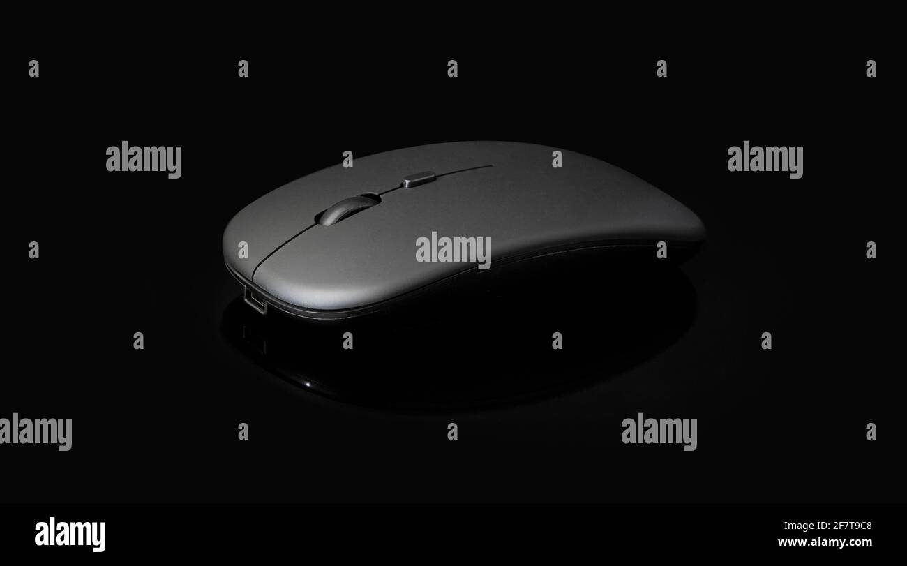 wireless black mouse isolated on black background with clipping path Stock Photo