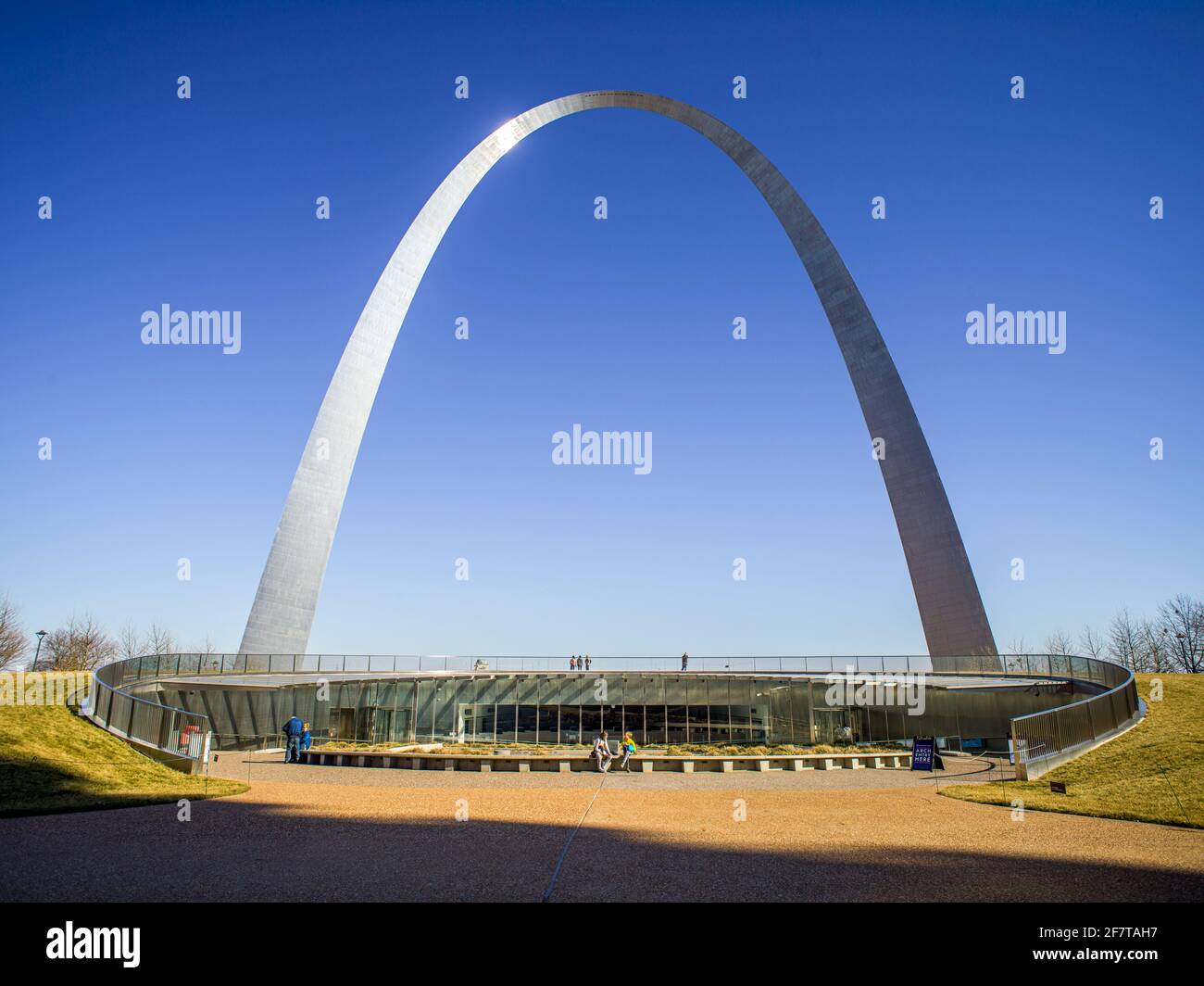 The Gateway Arch and tourist gather in courtyard outside entrance, St. Louis, Missouri Stock Photo