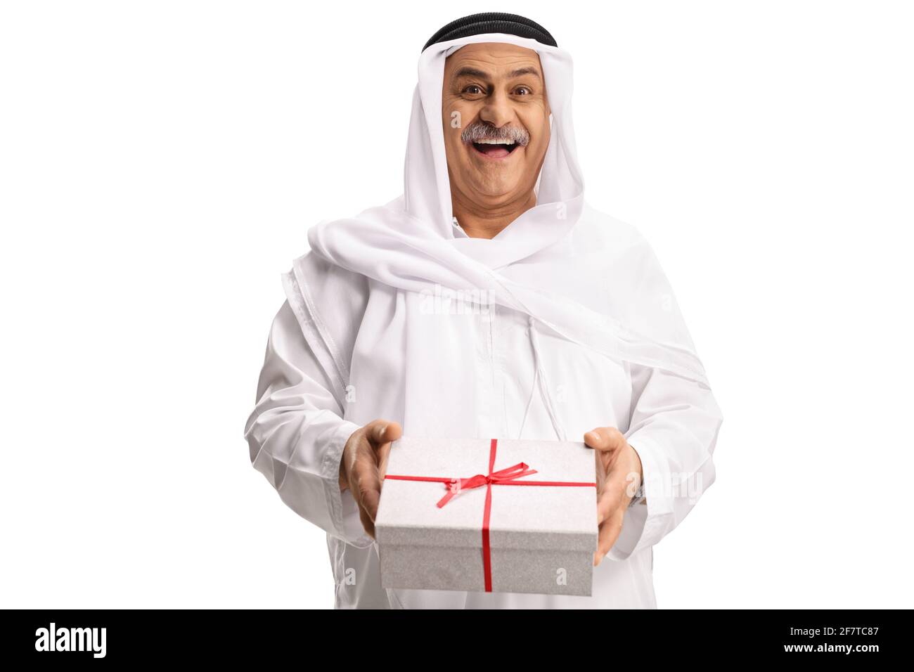 Cheerful mature arab man holding a gift box isolated on white background Stock Photo