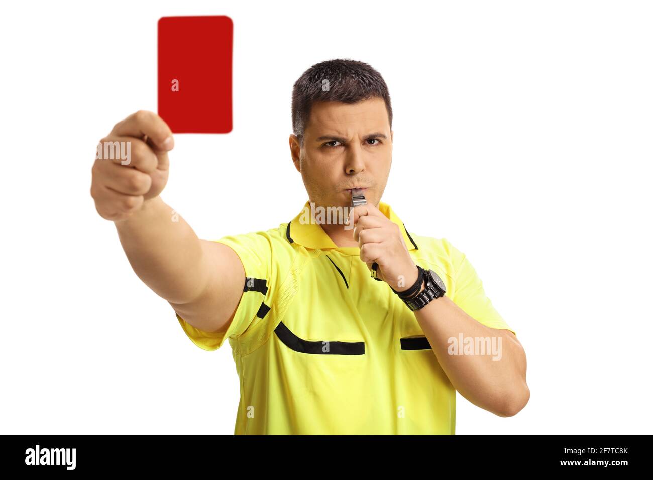 Serious football referee blowing a whistle and showing a red card isolated on white background Stock Photo