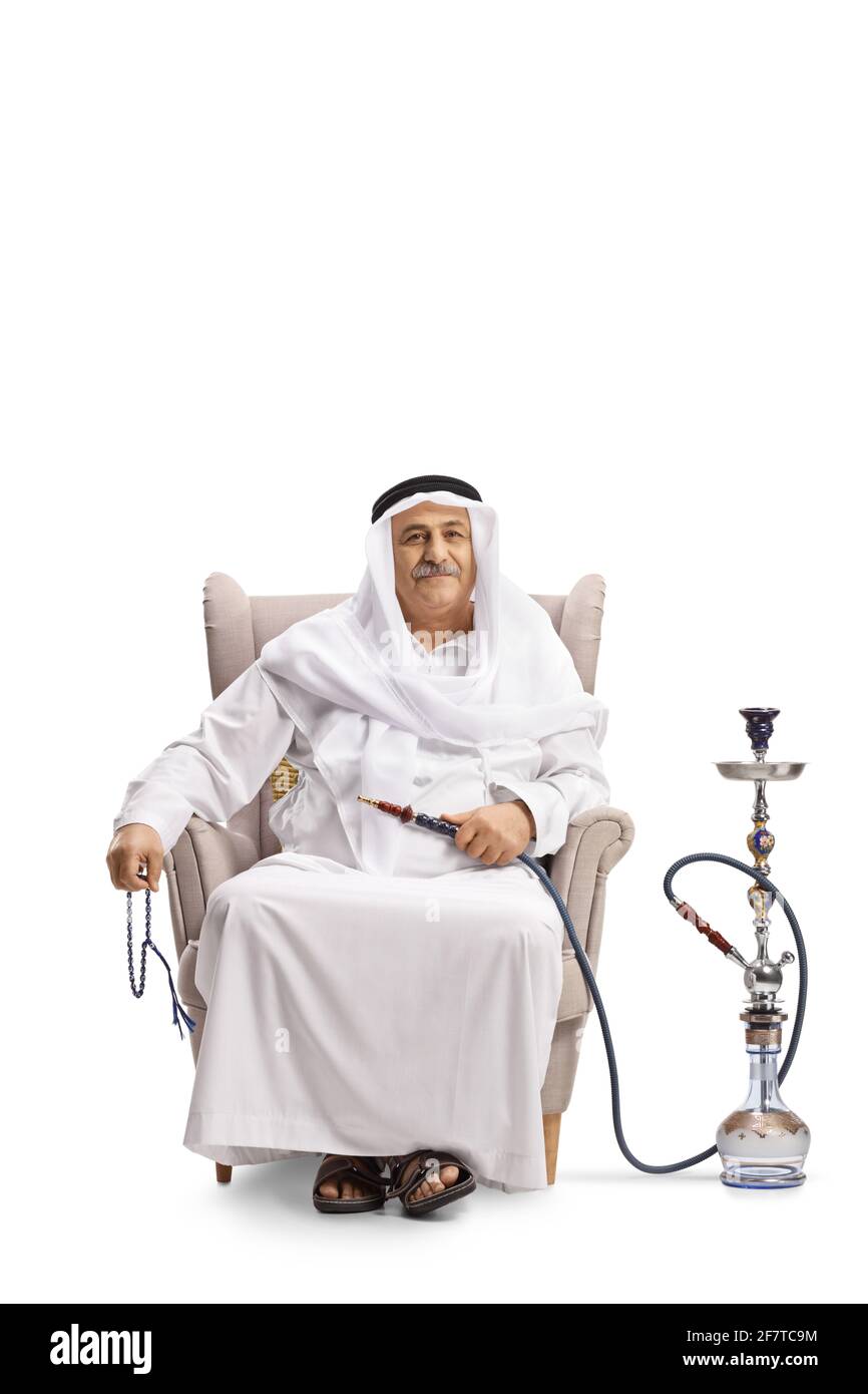 Mature arab man sitting in an armchair with a shisha isolated on white background Stock Photo