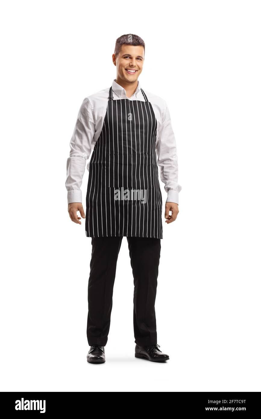 Full length portrait of a young man chef wearing an apron isolated on white background Stock