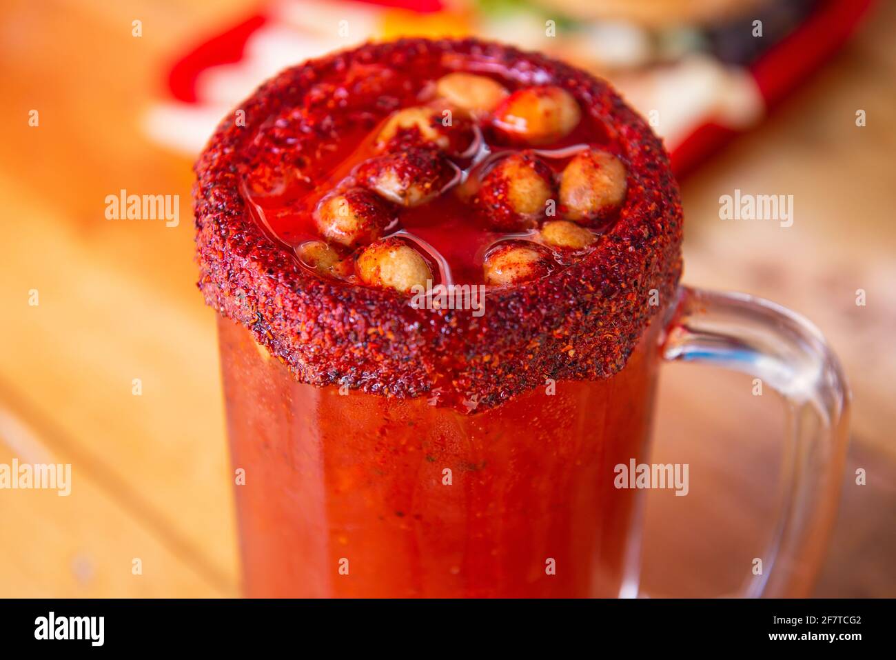 Closeup of a fresh Mexican spicy Michelada drink in a saltrimmed glass