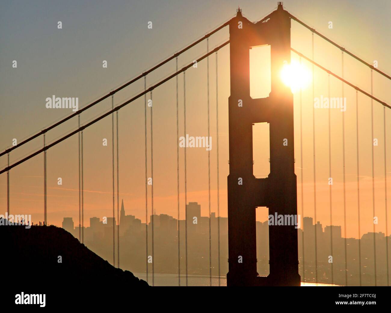 Sunrise over San Francisco with a Golden gate Bridge towerin the foreground. Stock Photo