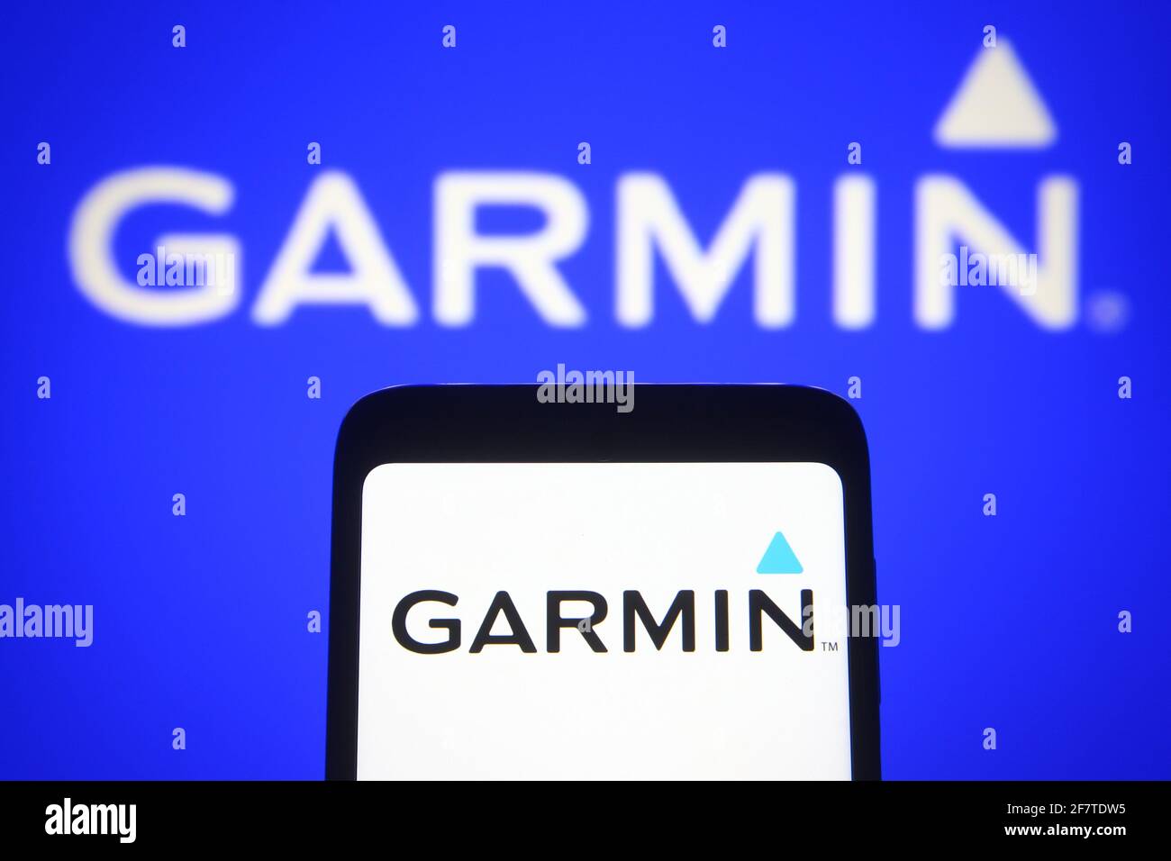blod Betaling massefylde In this photo illustration the Garmin logo of an US technology company is  seen on a smartphone and a pc screen Stock Photo - Alamy