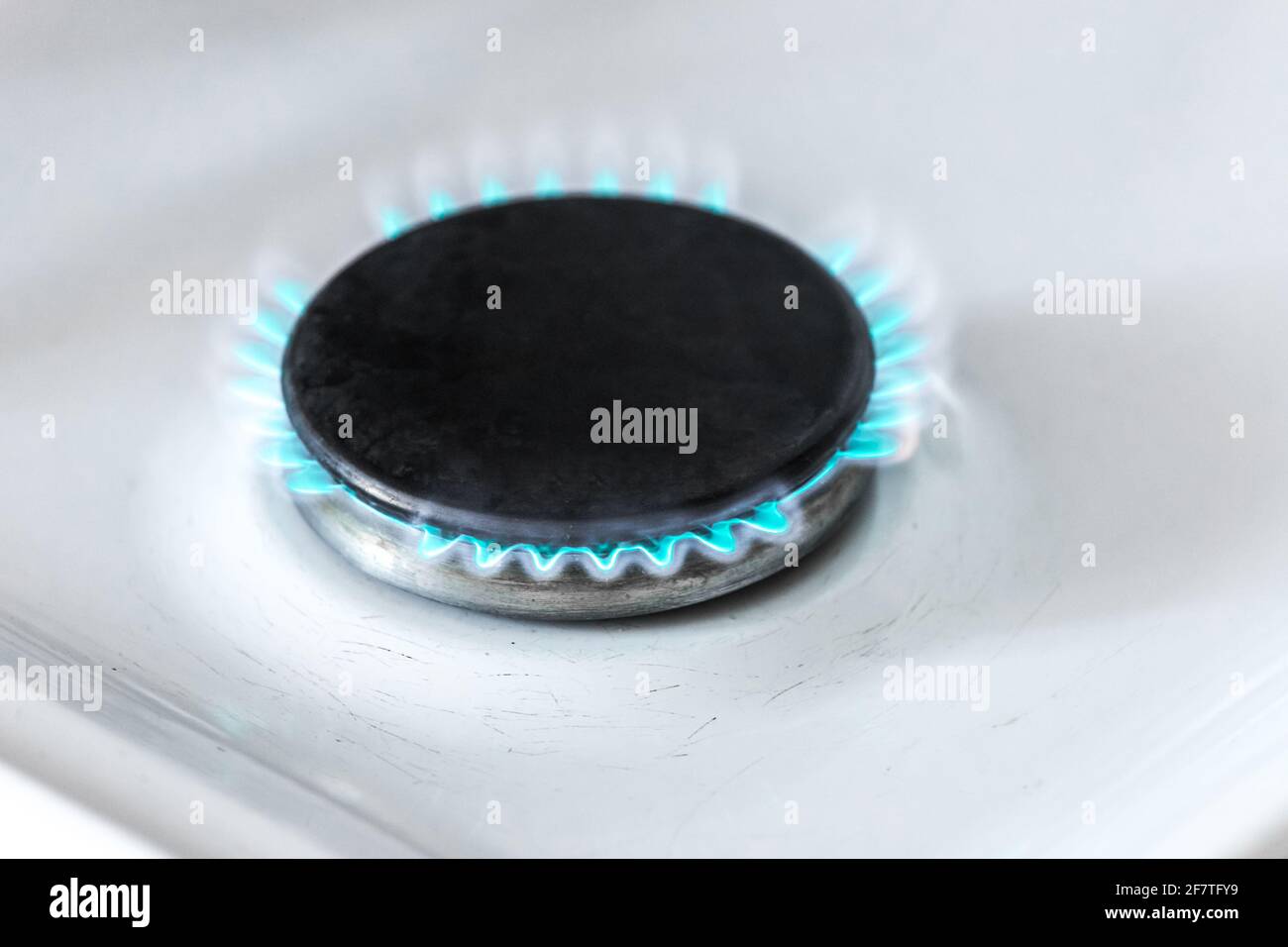 Gas burner with a blue flame on a gas stove, closeup Stock Photo Alamy