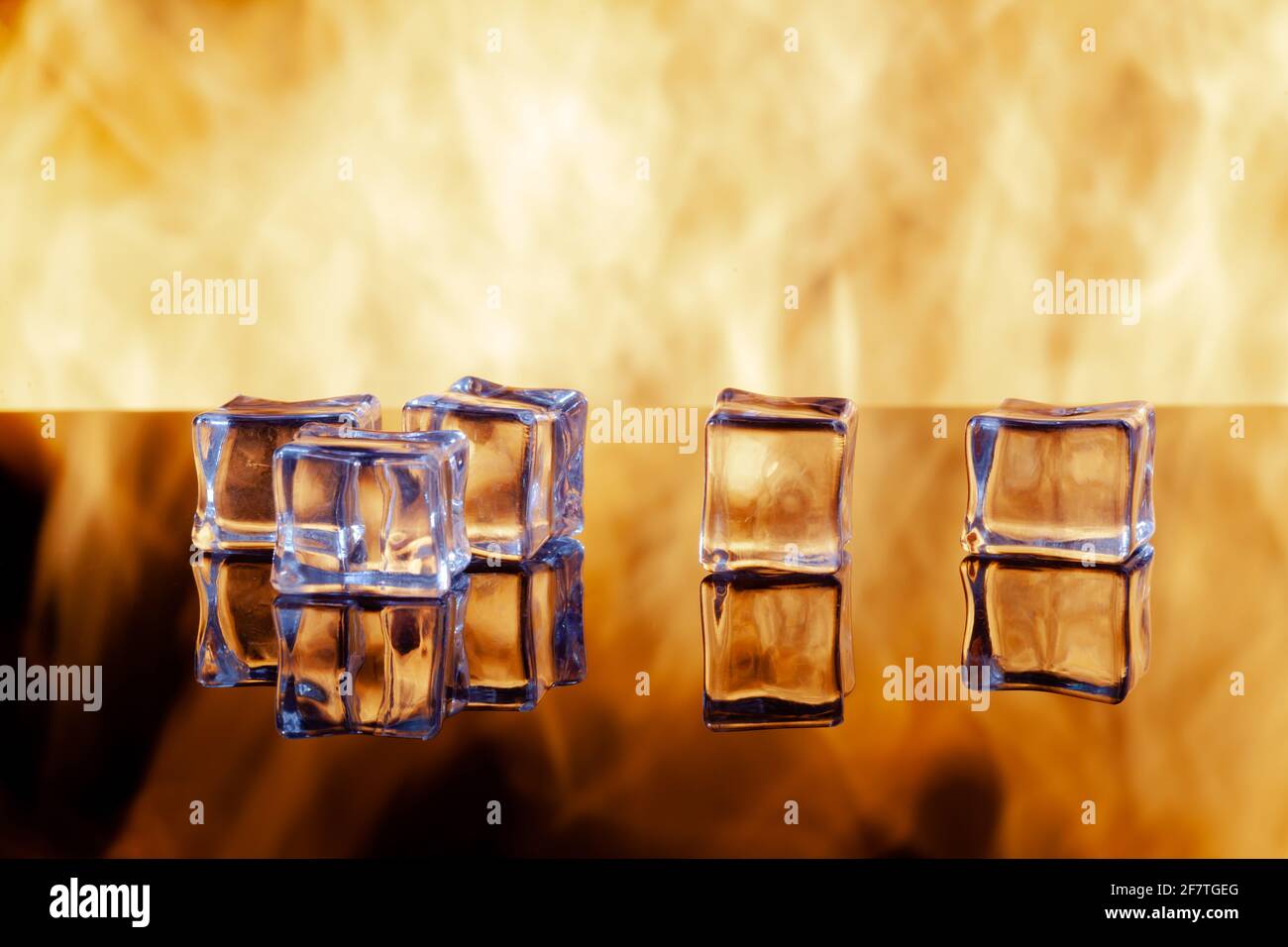five ice cubes on a black mirrored surface Stock Photo