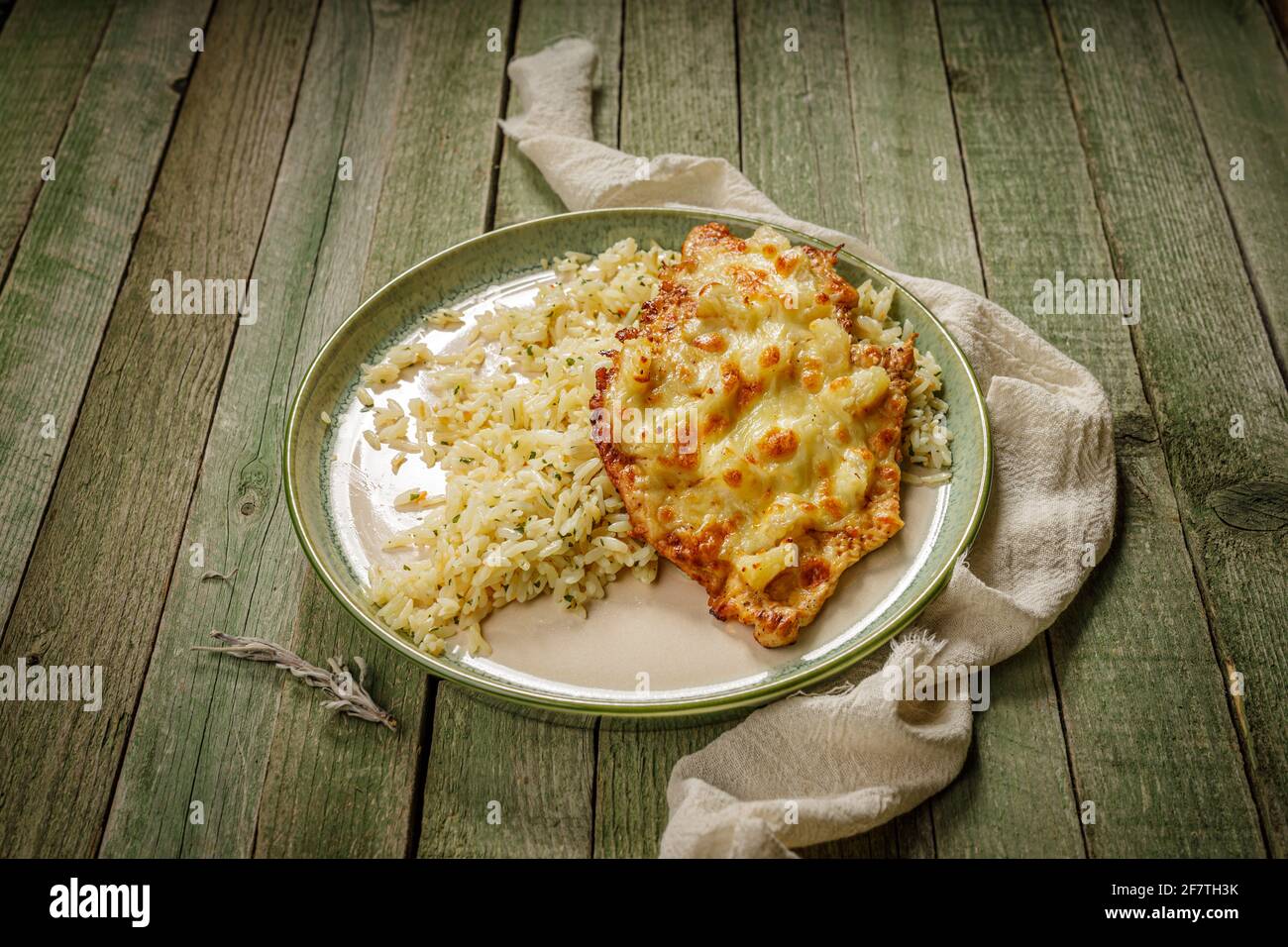 grilled chicken with ananas and cheese with rice in a green elegant porcelain plate, on the old, green wood table Photo - Alamy
