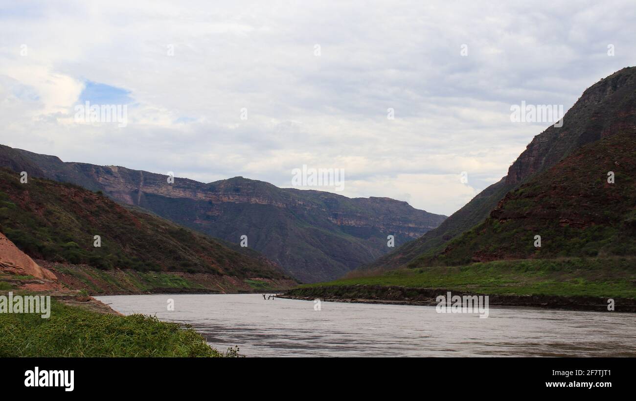 River flowing through rocky mountains Stock Photo - Alamy
