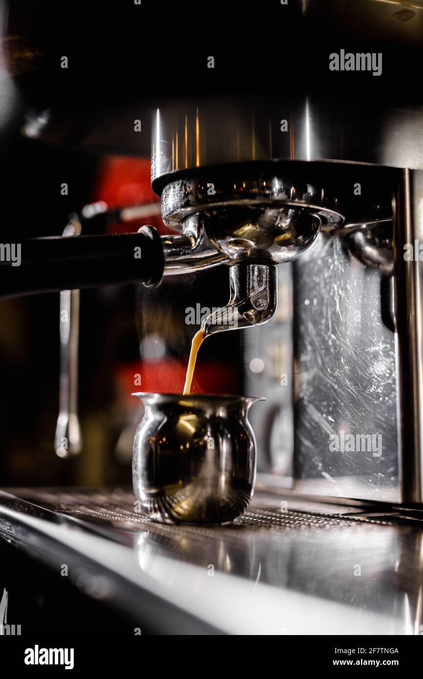 Close-up of professional coffee machine. Pouring espresso. Barista preparing deliciouse fresh hot coffee Stock Photo