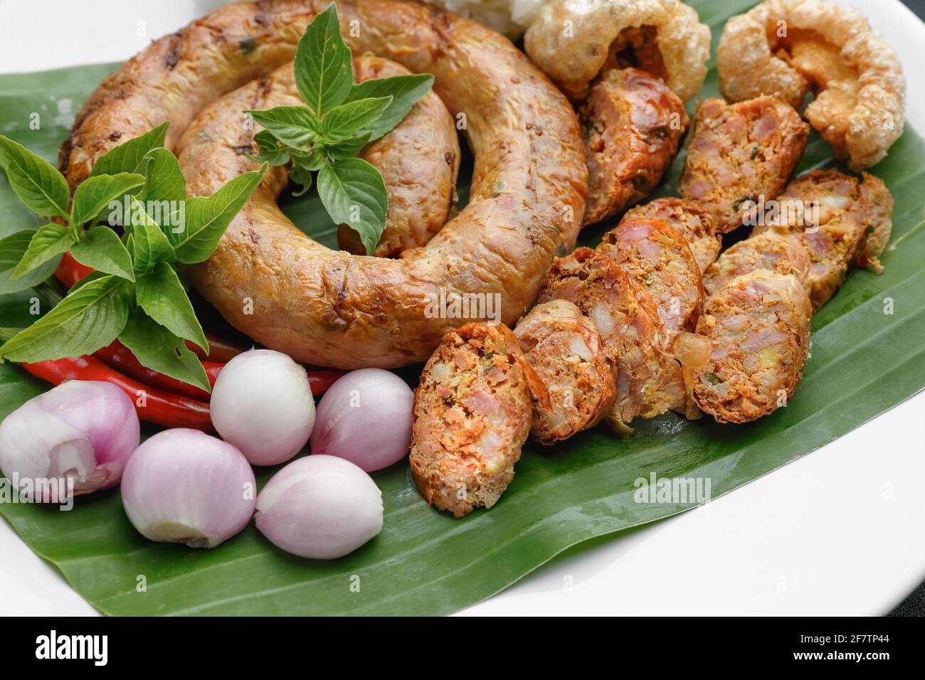 Northern Thai Sausage or Sai-Aua , filled with chopped lemongrass, galangal, kaffir lime, coriander and red curry paste. Stock Photo
