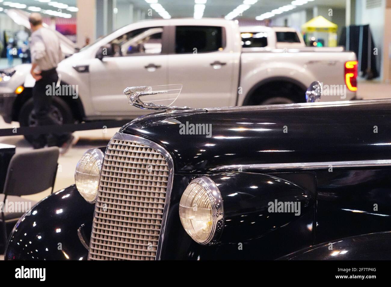 St. Louis, United States. 09th Apr, 2021. A 1937 Cadillac Fleetwood Sedan sits in the foreground as visitors to the St. Louis Auto Show, check out a new Ford Ranger truck, at America's Center and The Dome in St. Louis on Friday, April 9, 2021. Photo by Bill Greenblatt/UPI Credit: UPI/Alamy Live News Stock Photo