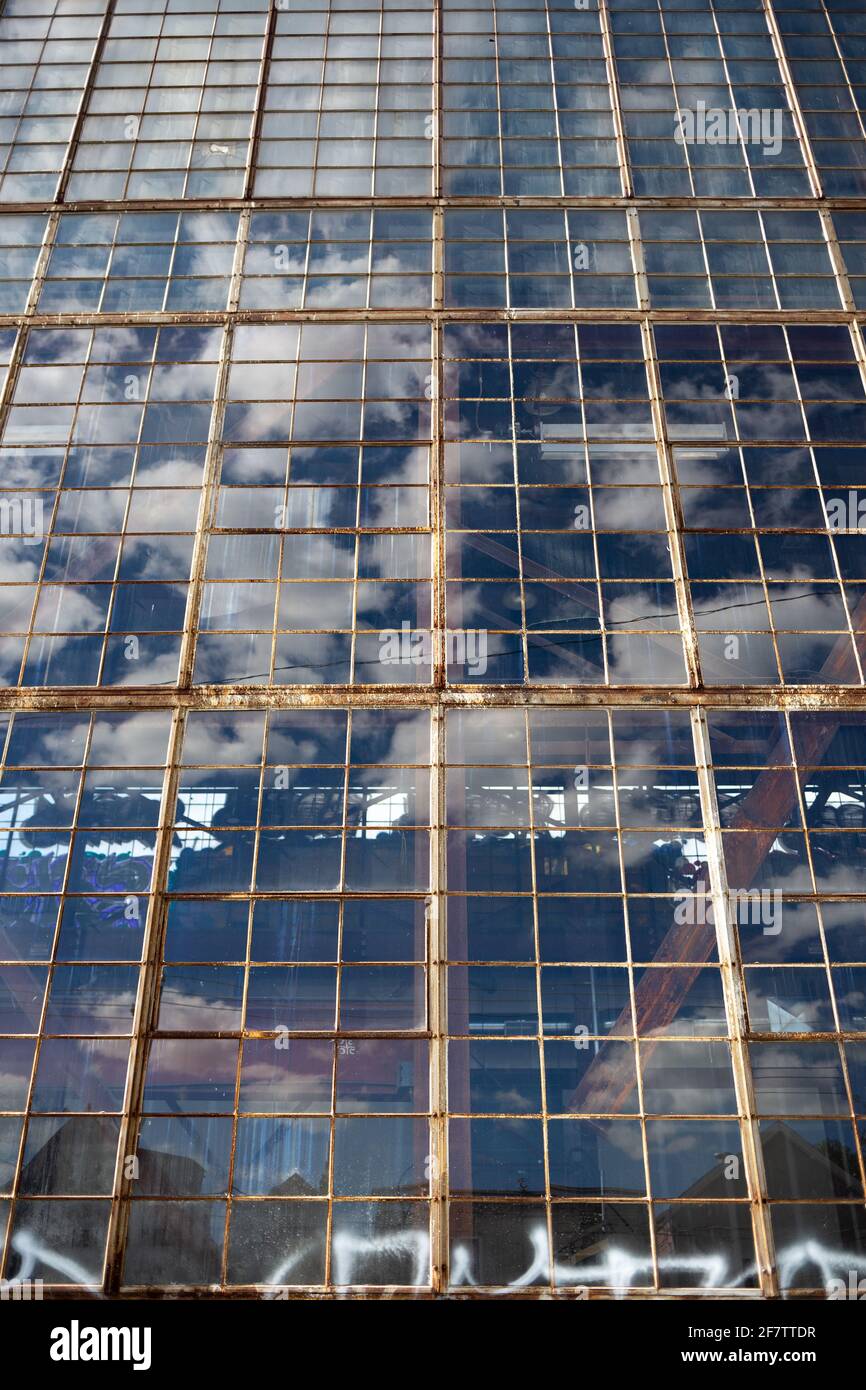 Clouds reflected in the rusty windows of a building in Toronto, ON, Canada. Stock Photo